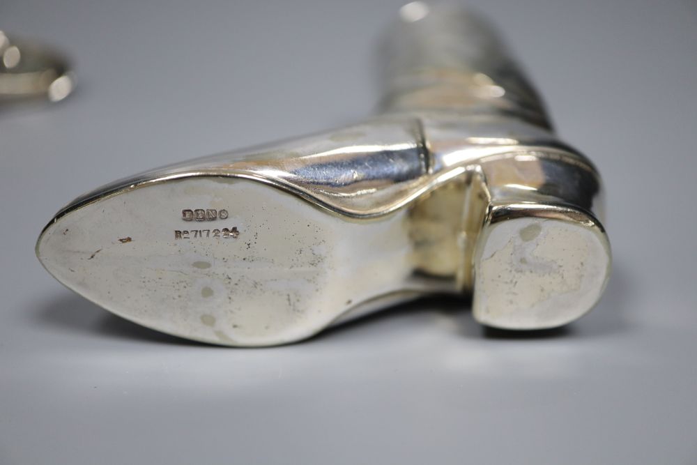 A silver novelty boot pin cushion, Levi & Salaman, Birmingham 1909 (lacking cushion),55m and a plated boot vesta